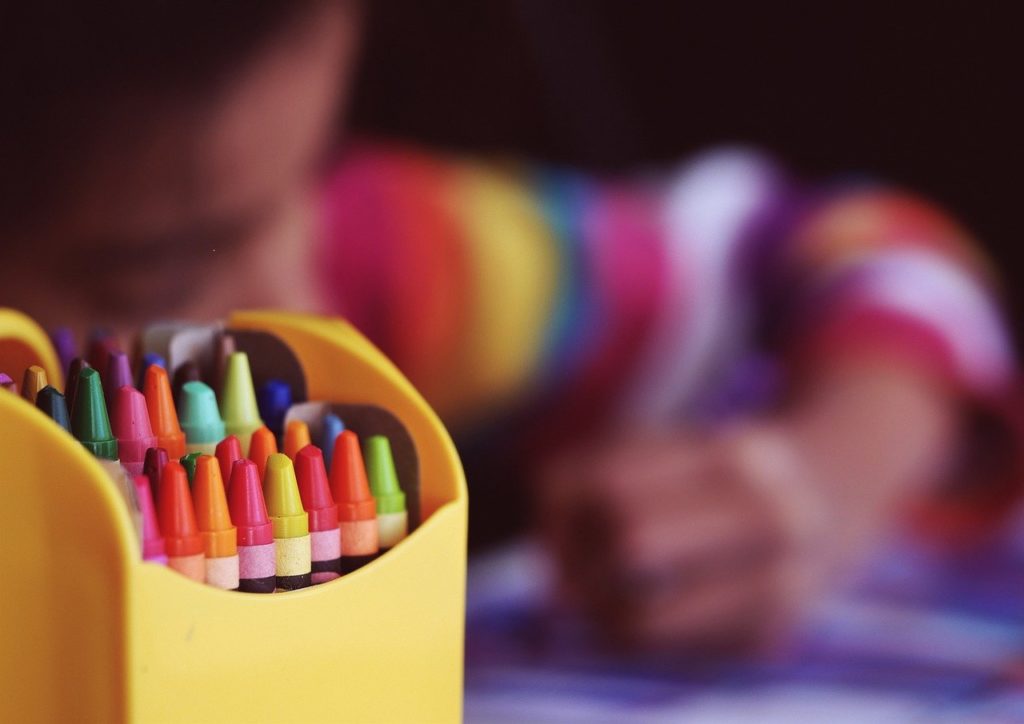 child coloring crayons